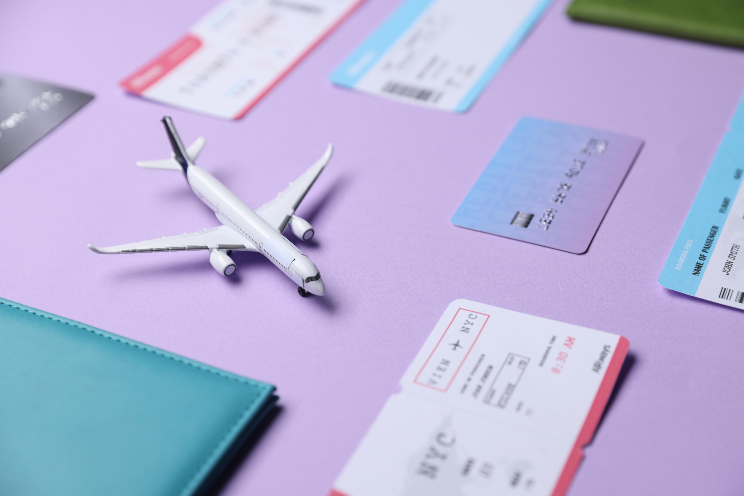 Airplane model, passport, credit card and flight tickets on viol