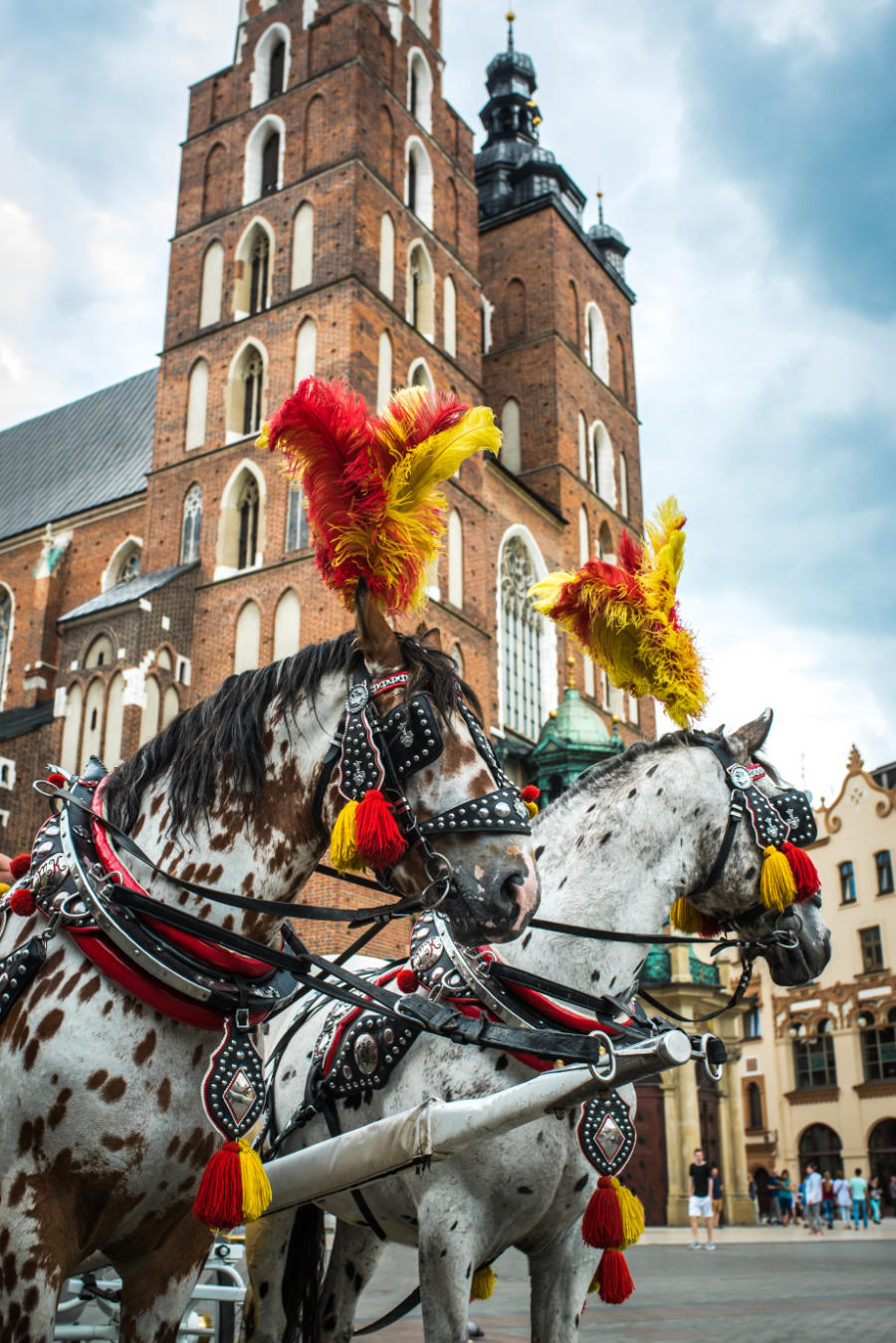 Stylized coach with horses in the historical square of Krakow