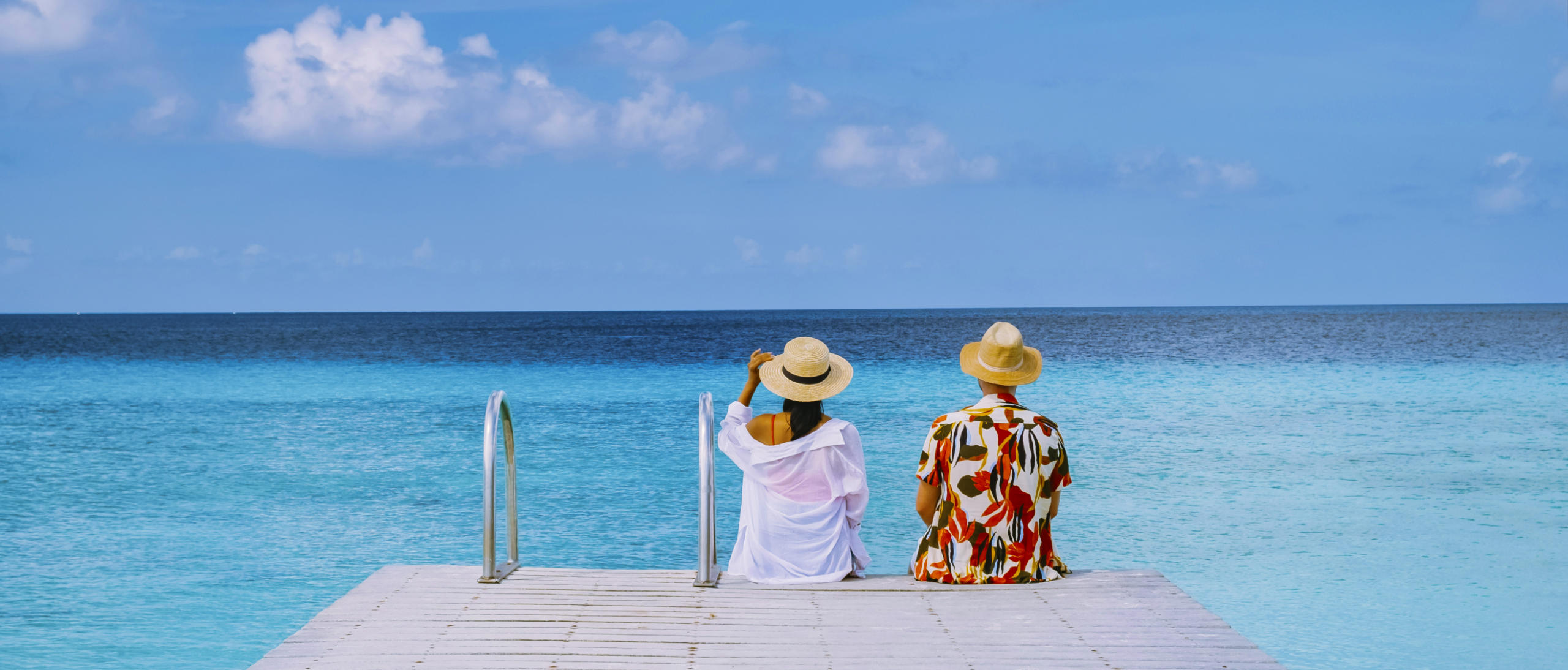 Couple visit Playa Porto Marie beach Curacao, white tropical beach with turqouse water ocean
